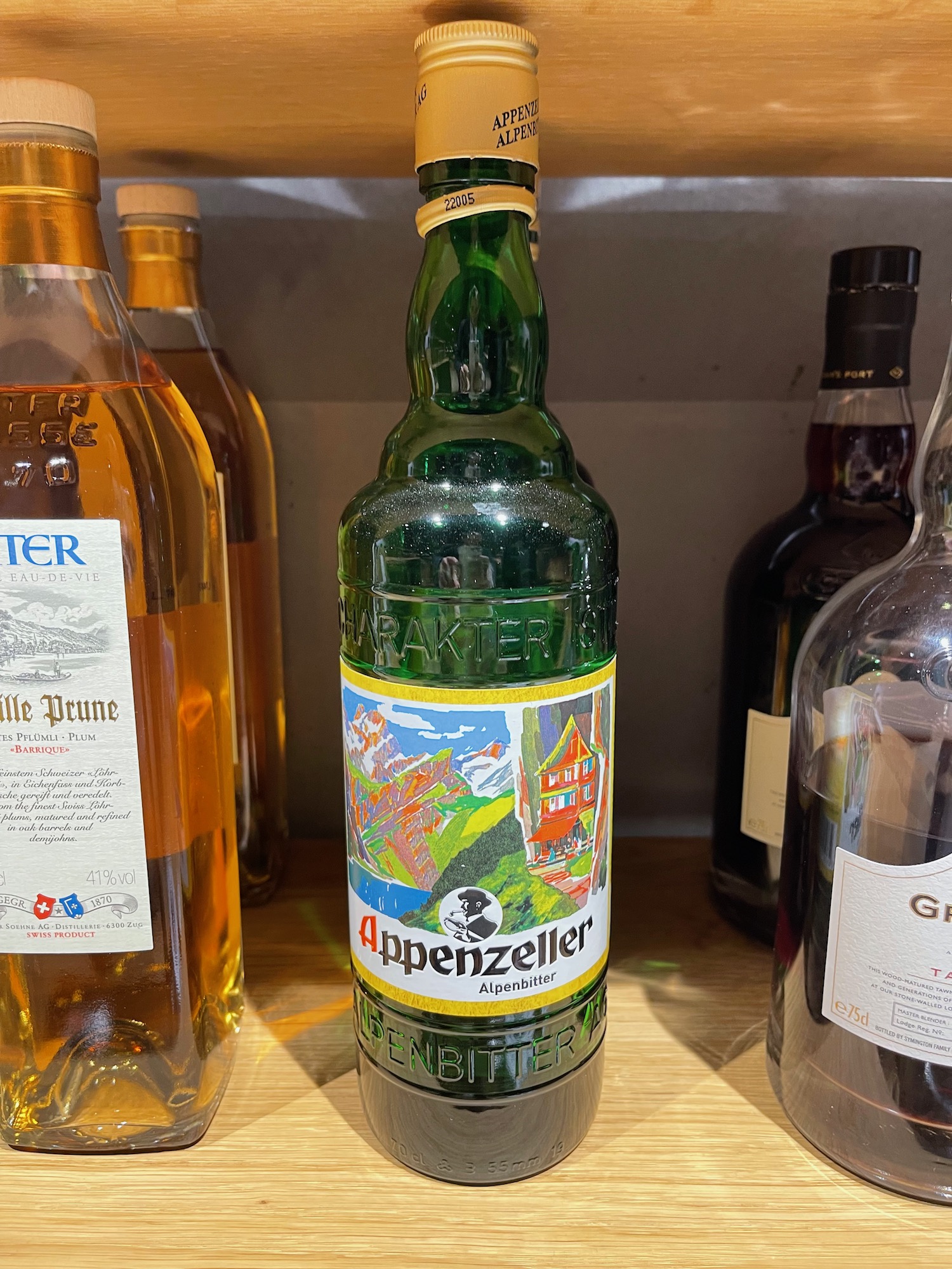 a green bottle of liquor on a shelf