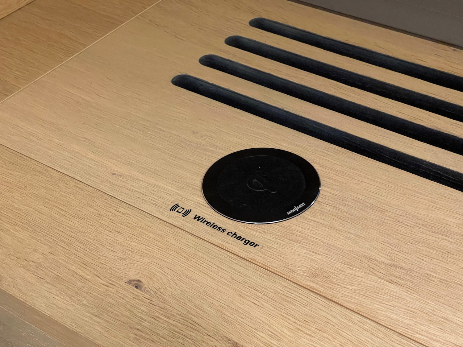 a black circular object on a wooden surface