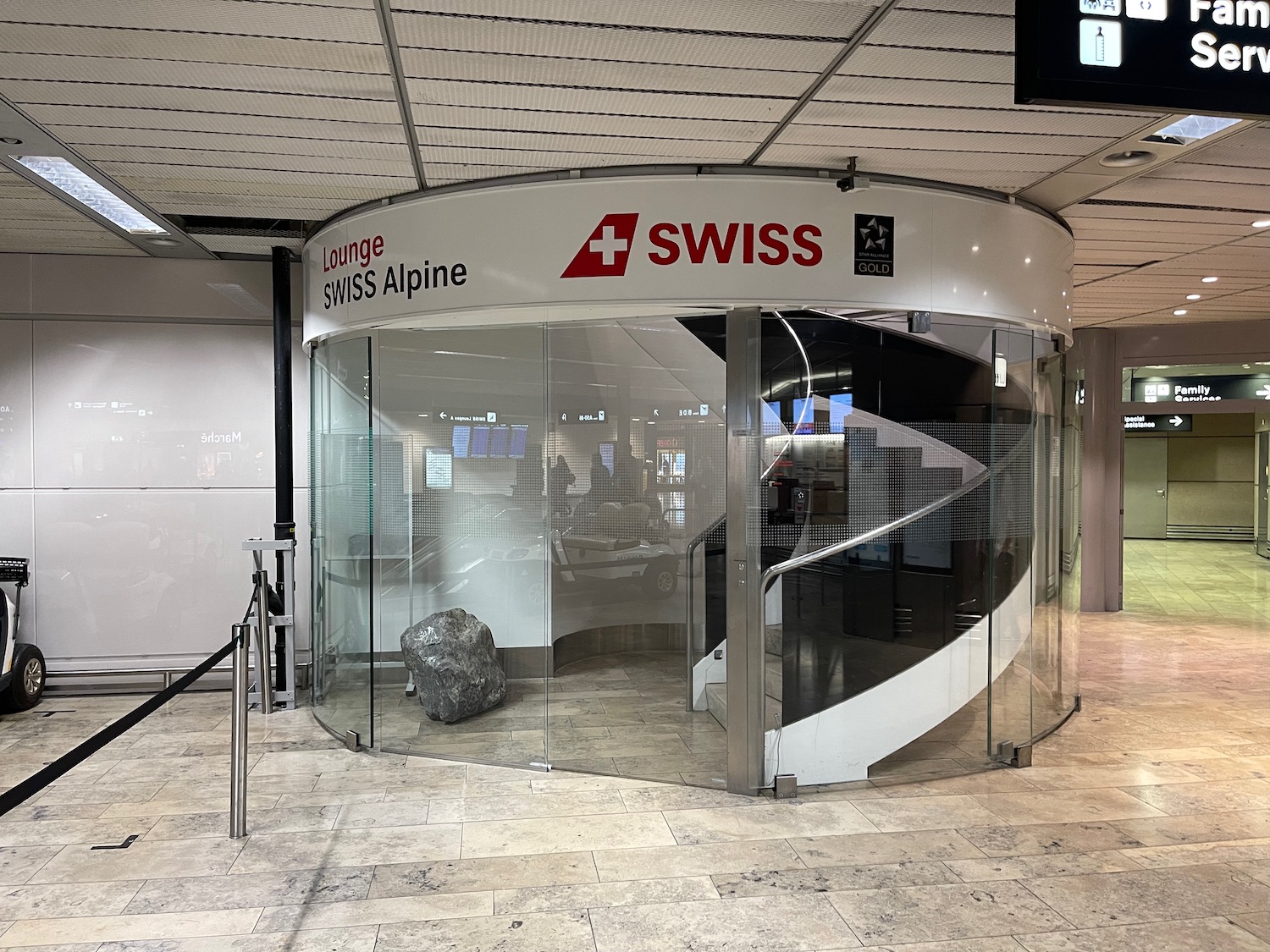 a glass door with a spiral staircase inside a building