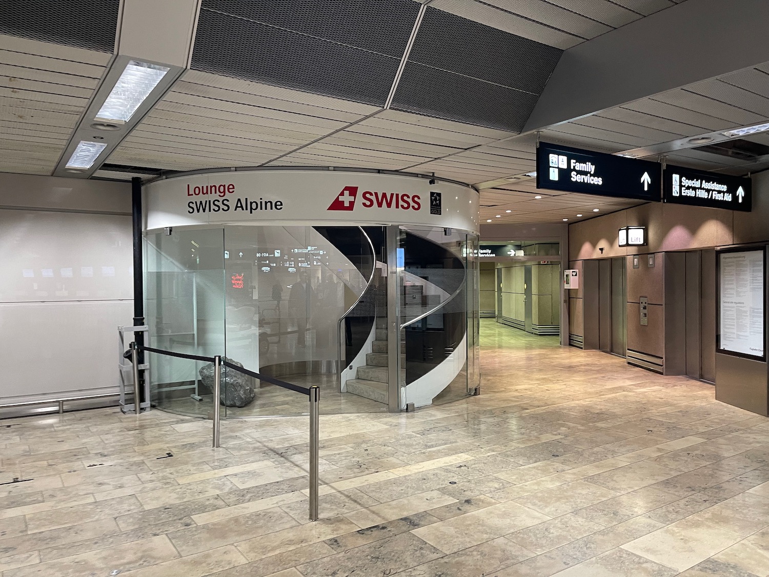 a glass door with a spiral staircase in a building