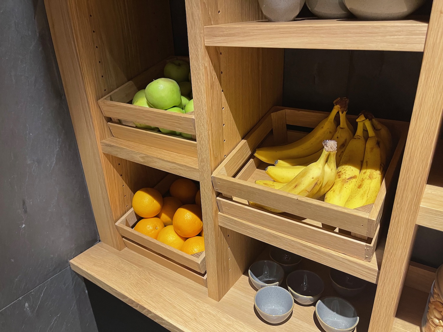 a wooden shelves with fruit in them