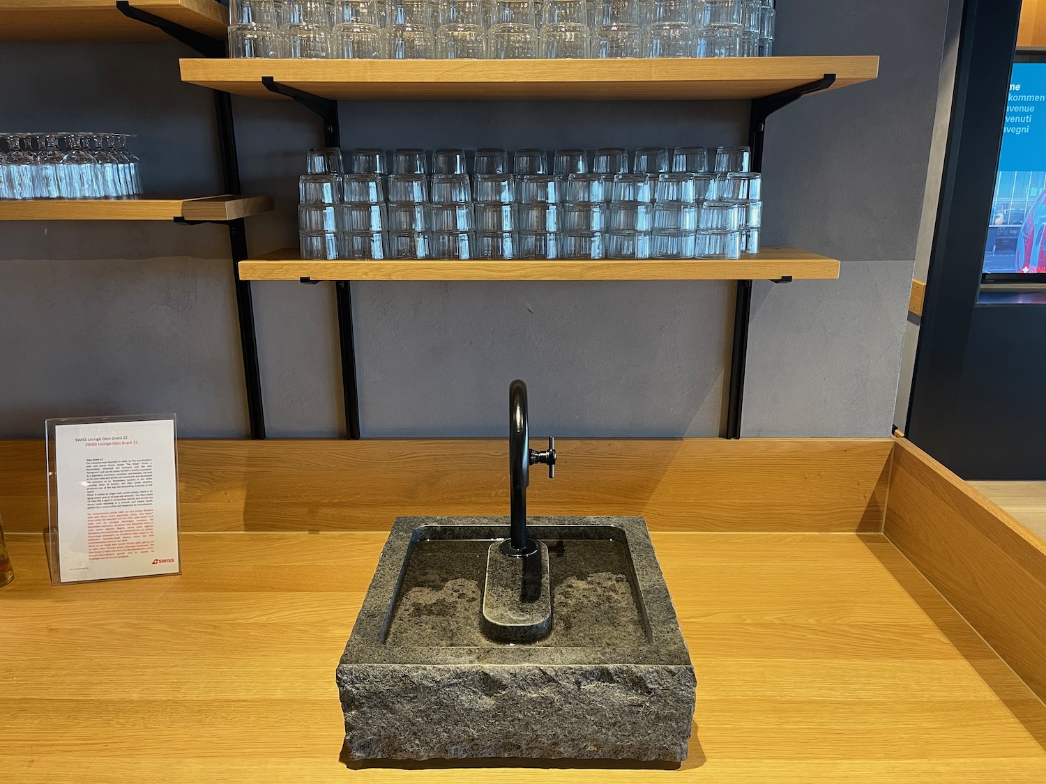 a stone sink with a faucet on a counter