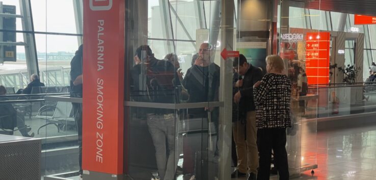people standing in a glass booth