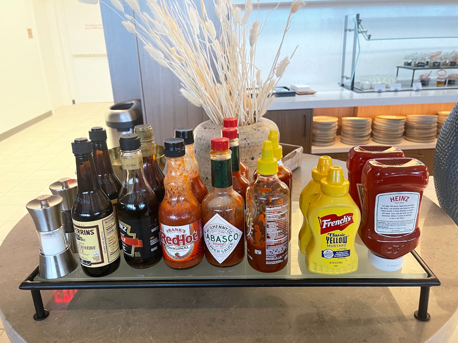 a table with bottles of hot sauce and other condiments