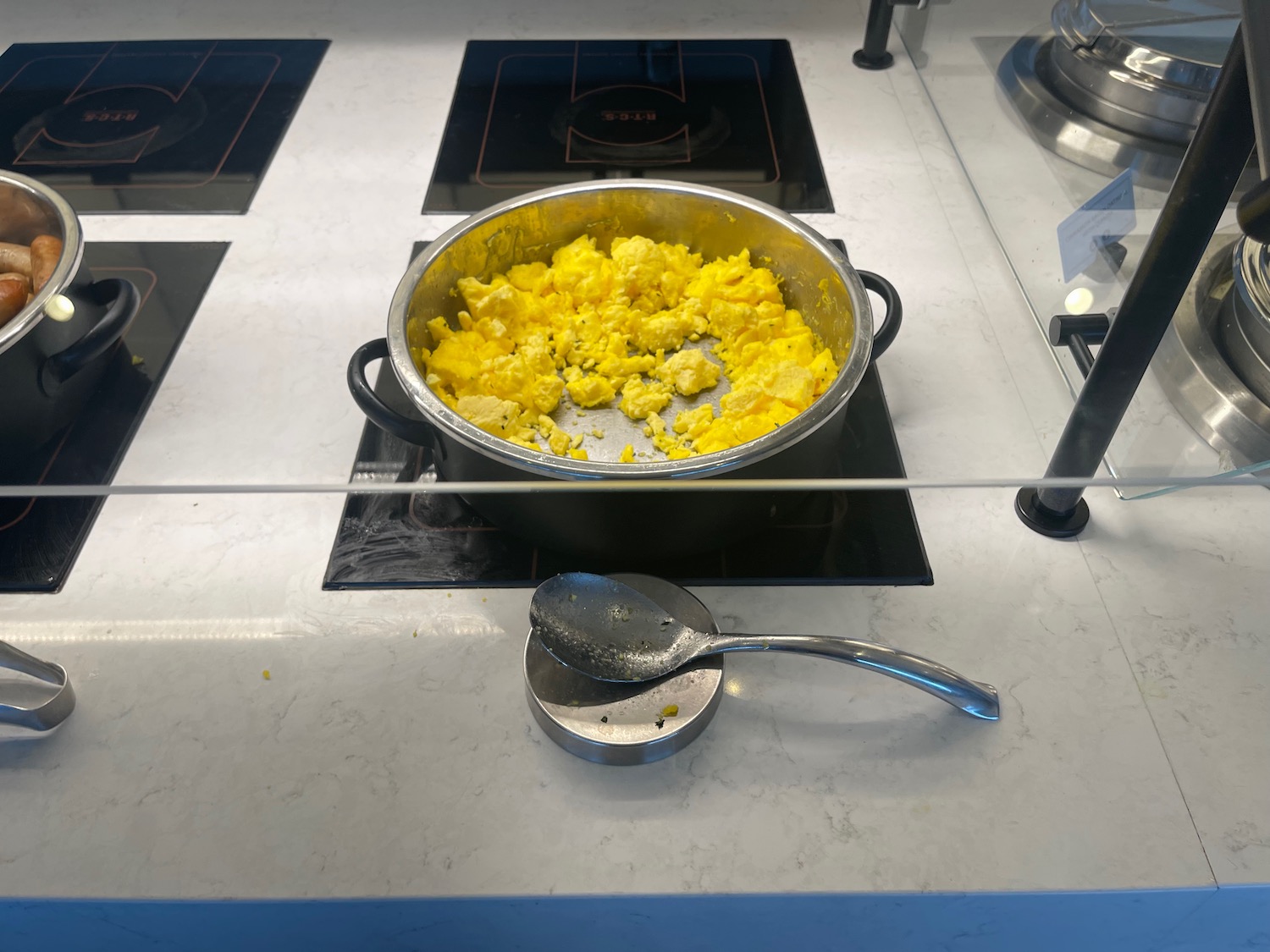a pan of scrambled eggs on a stove