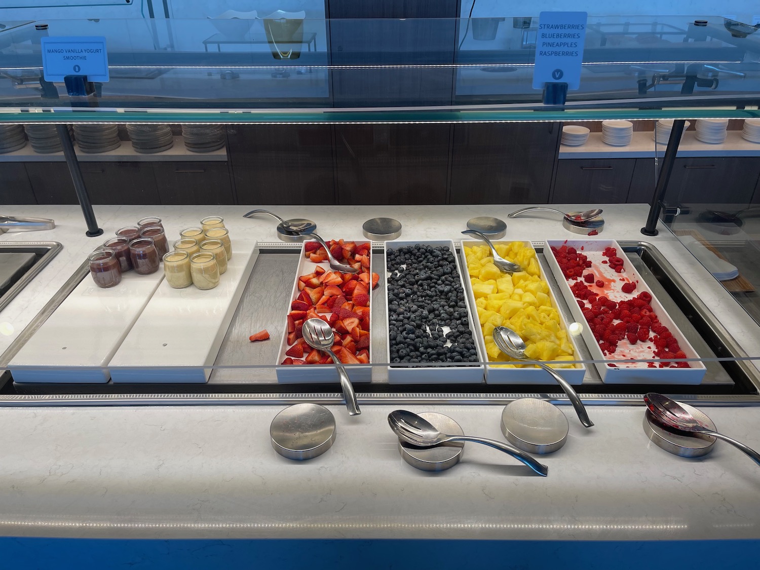 a buffet with different types of fruit in containers