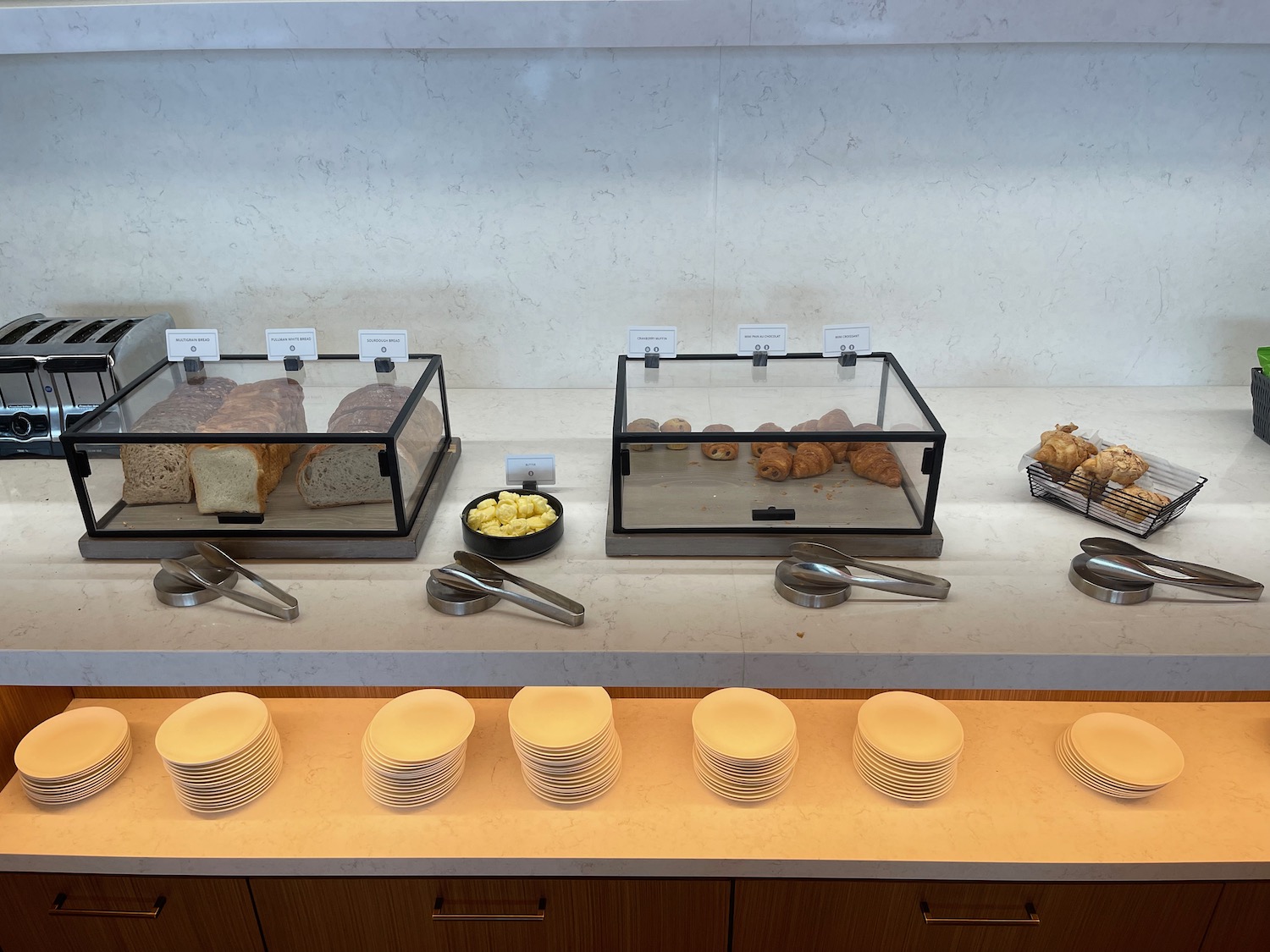 a row of plates and bowls of food on a counter