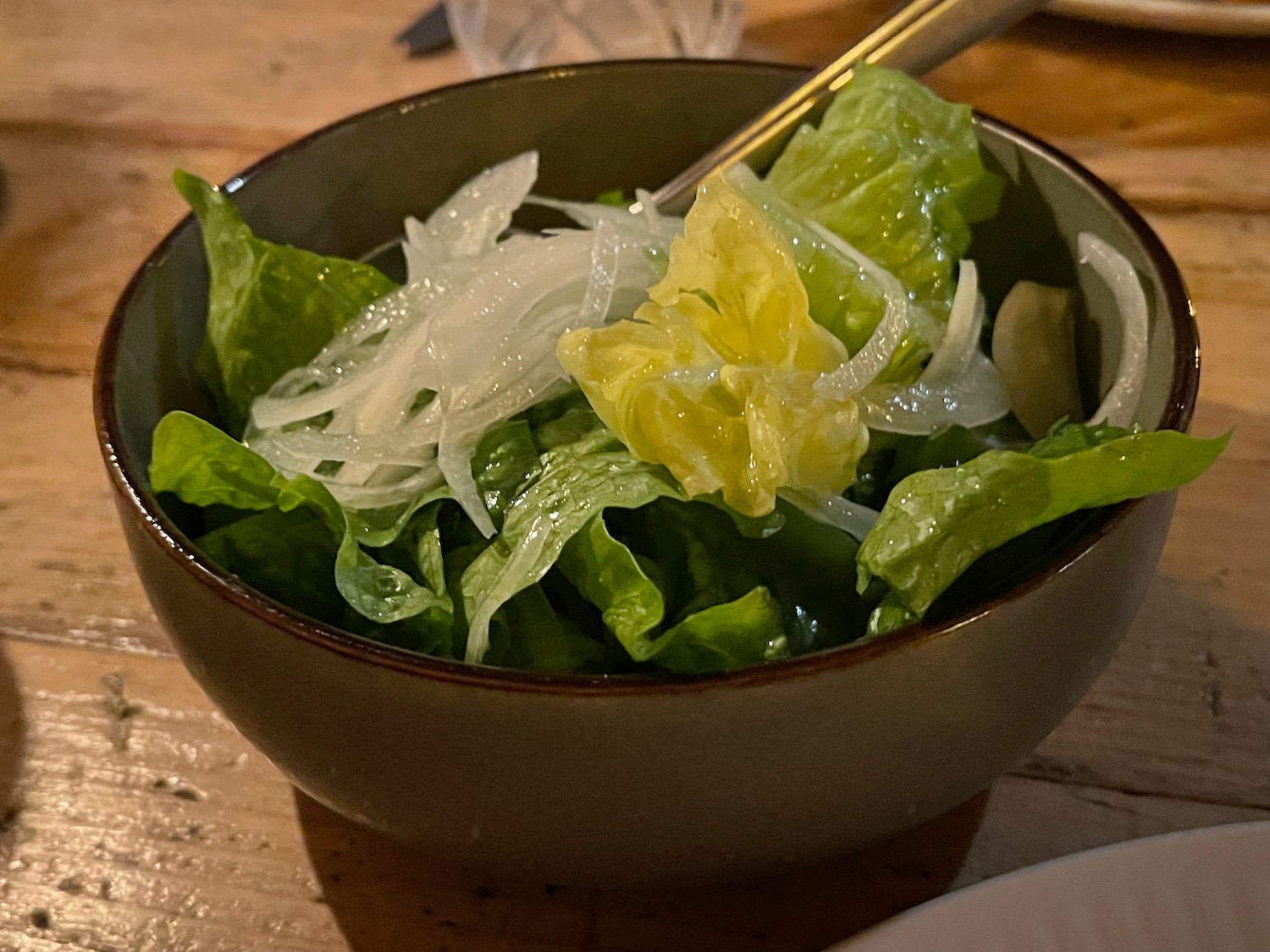 a bowl of salad with a fork