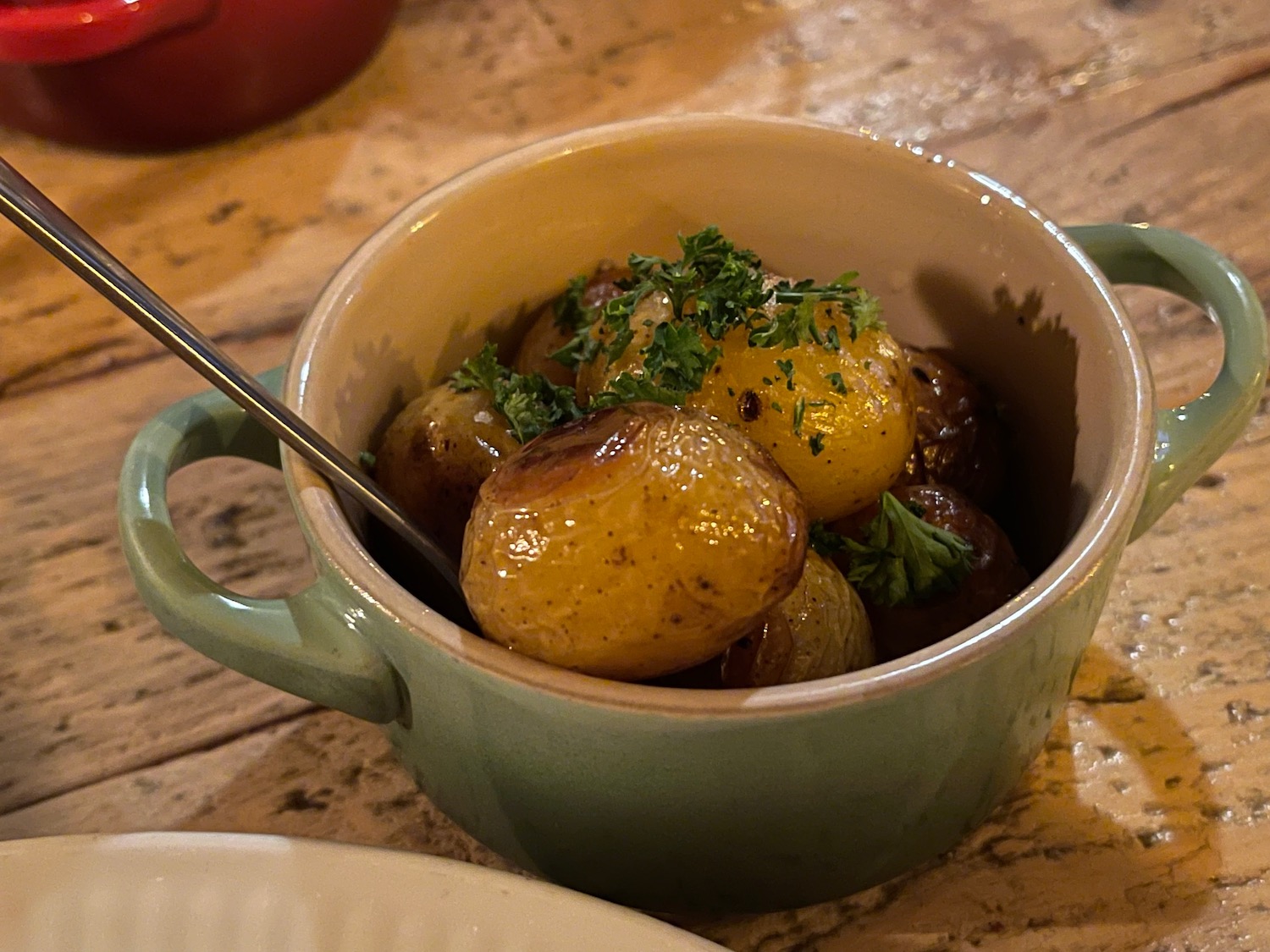 a bowl of potatoes with a spoon