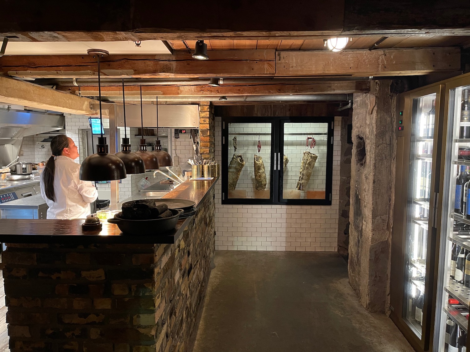 a man standing behind a counter in a restaurant