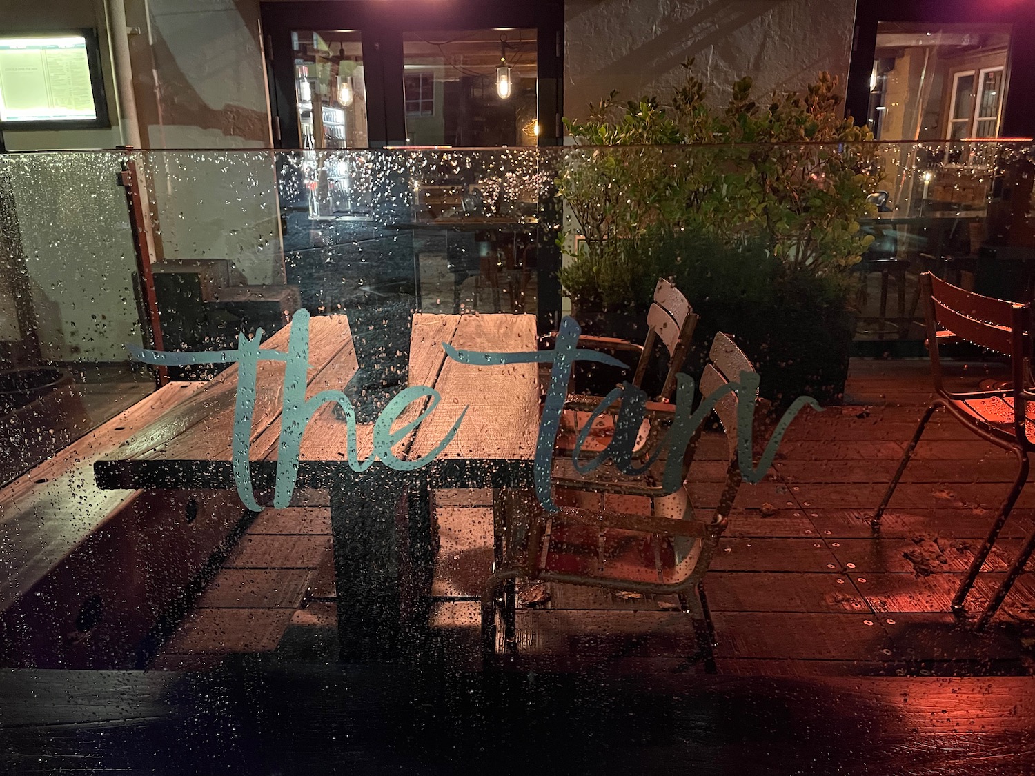 a table and chairs on a rainy day