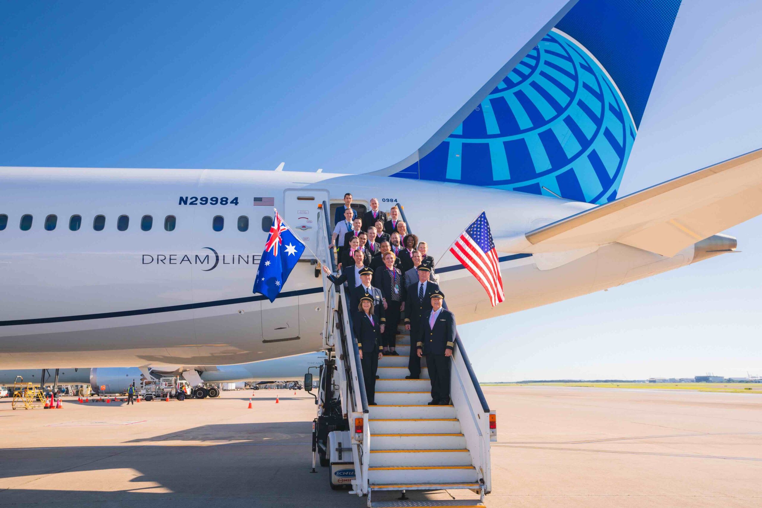 a group of people on stairs of an airplane