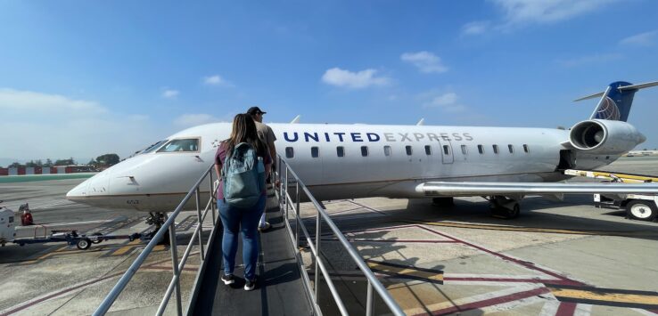 people walking on a ramp to a plane