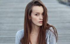 a woman with long hair looking at the camera