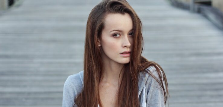 a woman with long hair looking at the camera