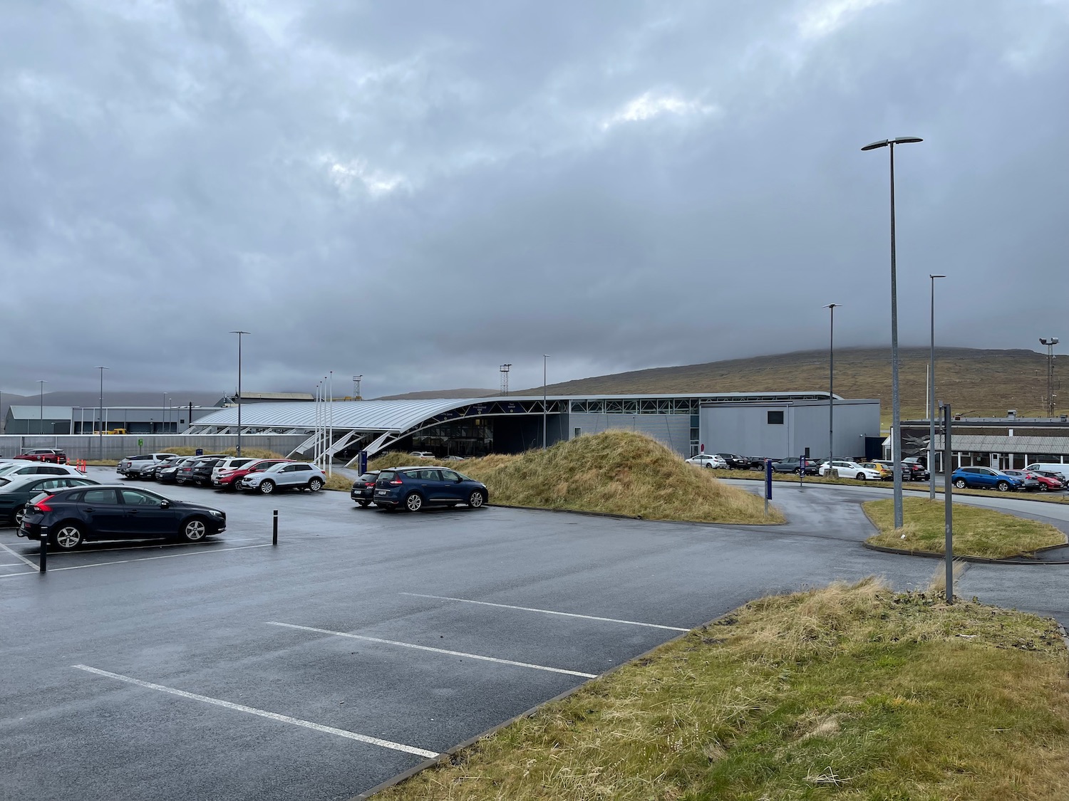 a parking lot with cars and grass