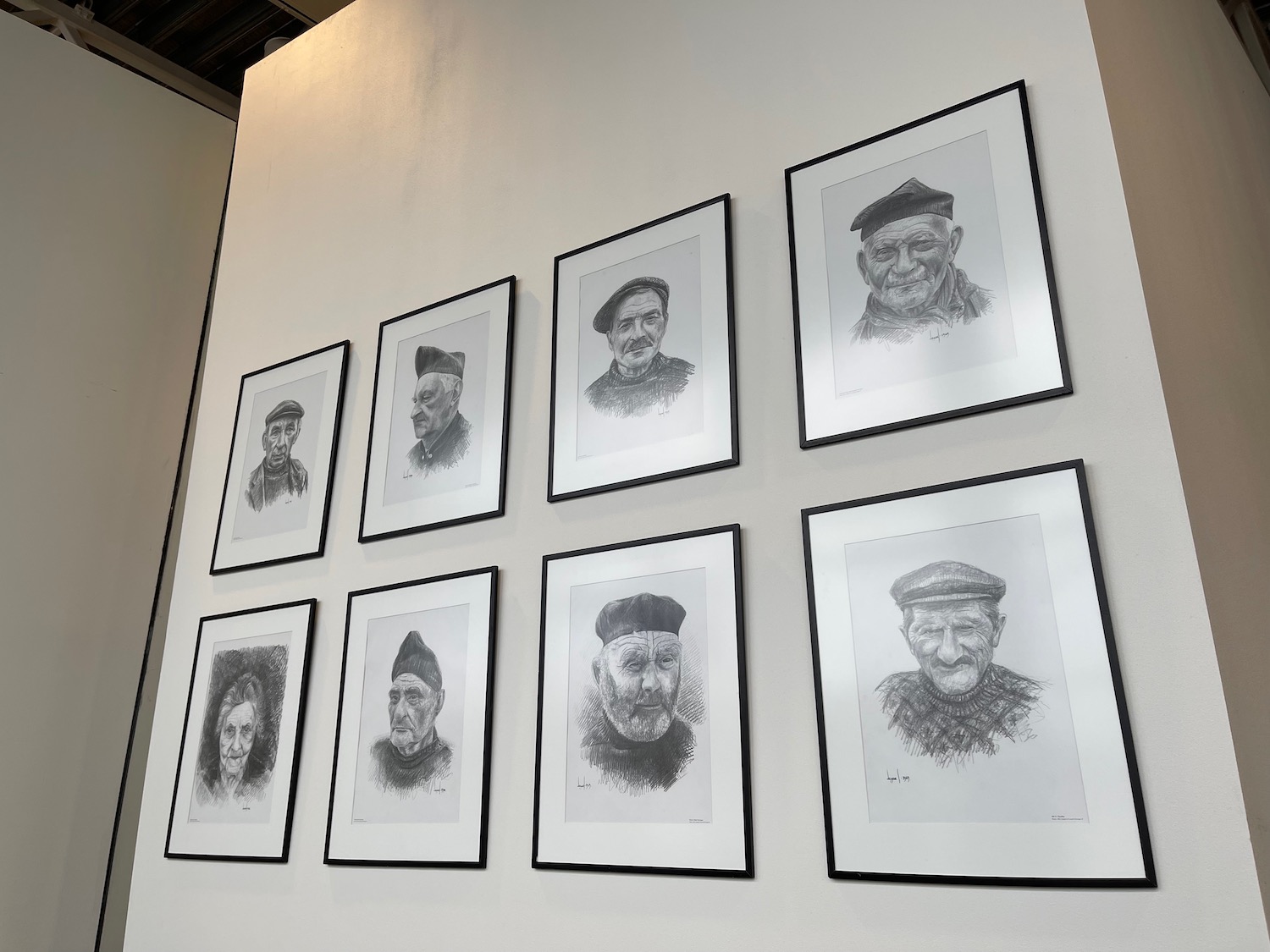 a group of framed pictures on a wall