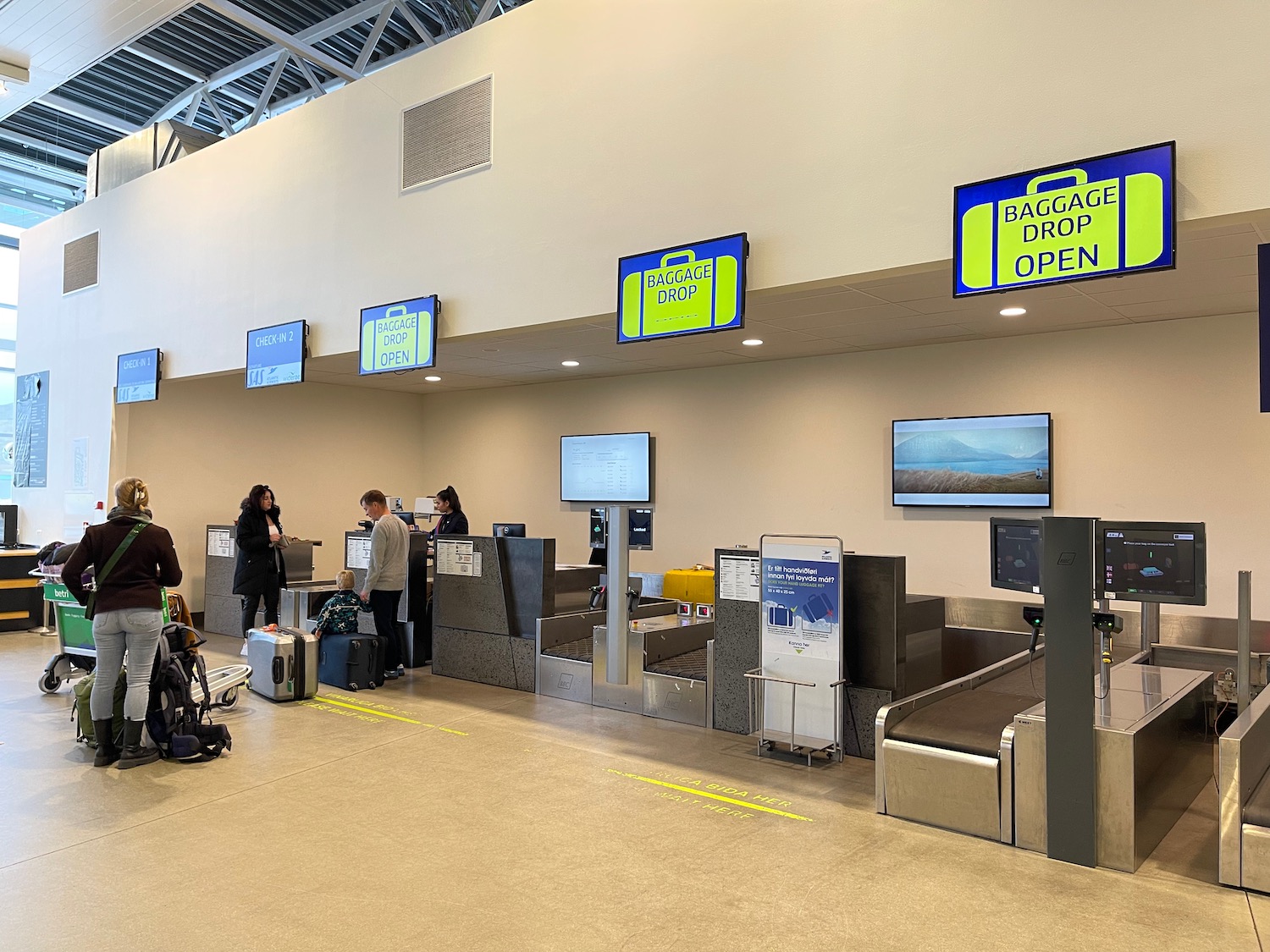 people standing in front of a check-in counter