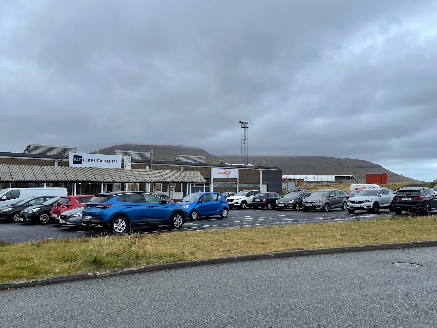 a parking lot with cars parked in front of a building