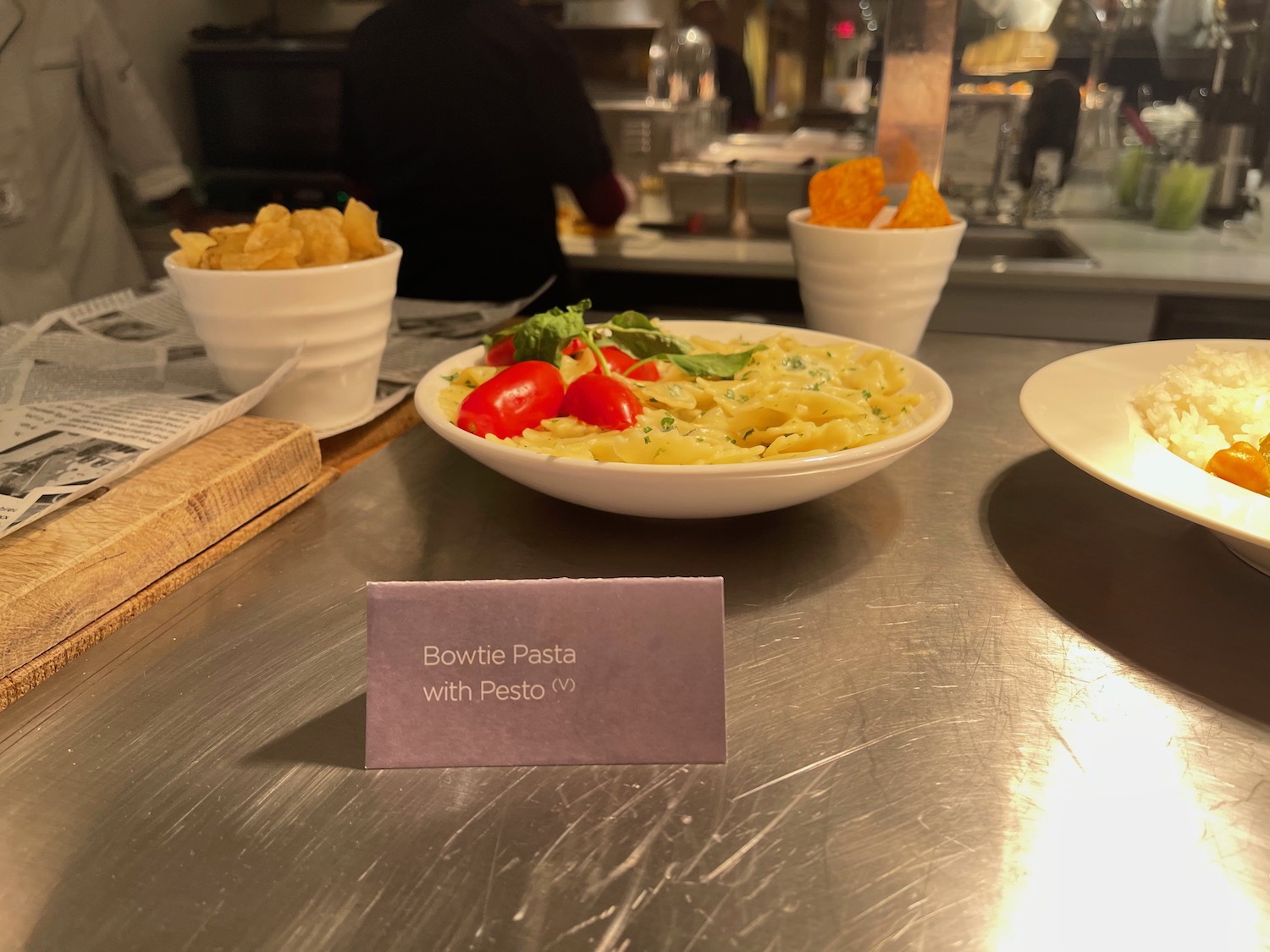 a plate of pasta and chips on a table