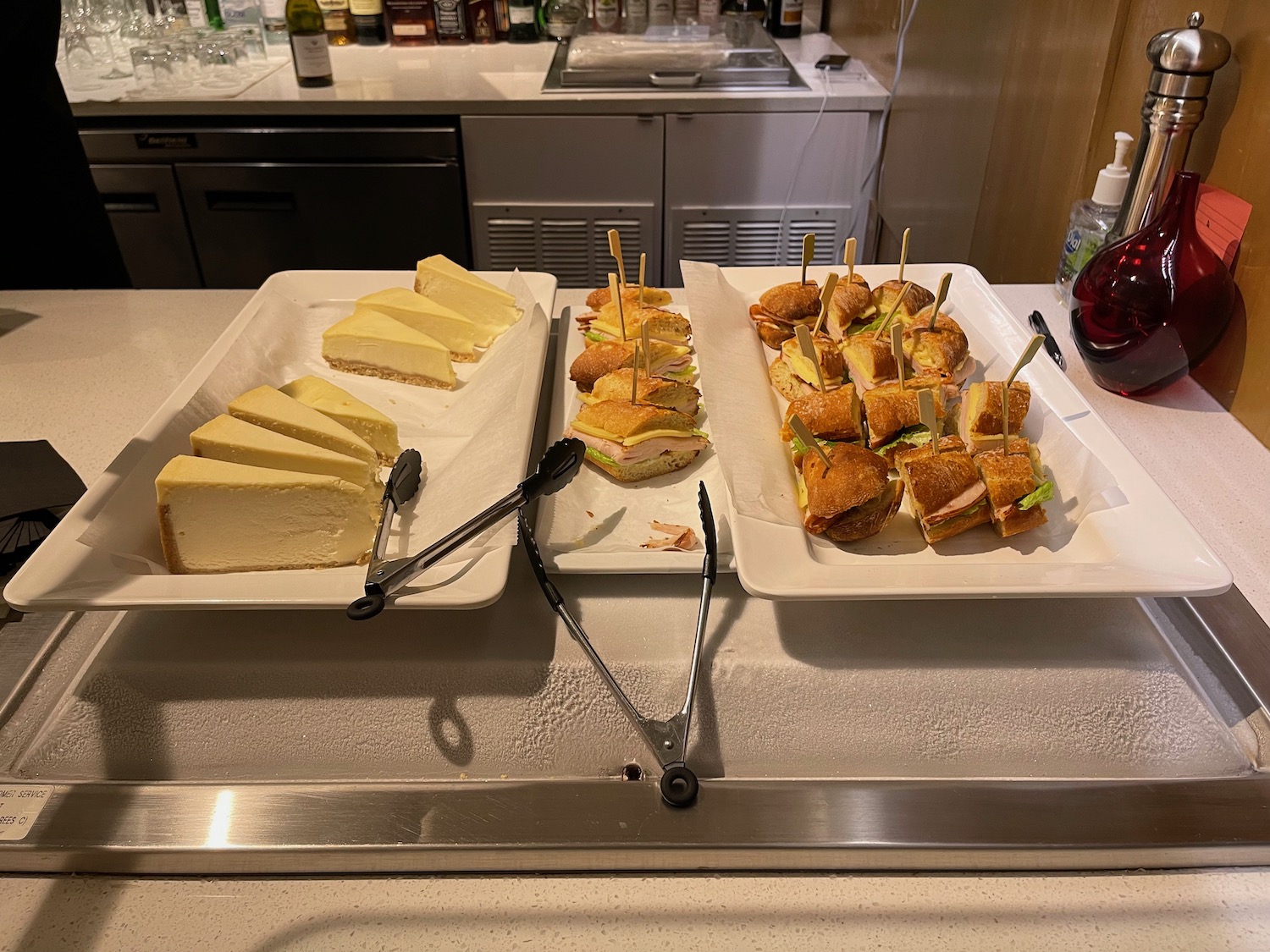 a trays of sandwiches and cheese on a counter