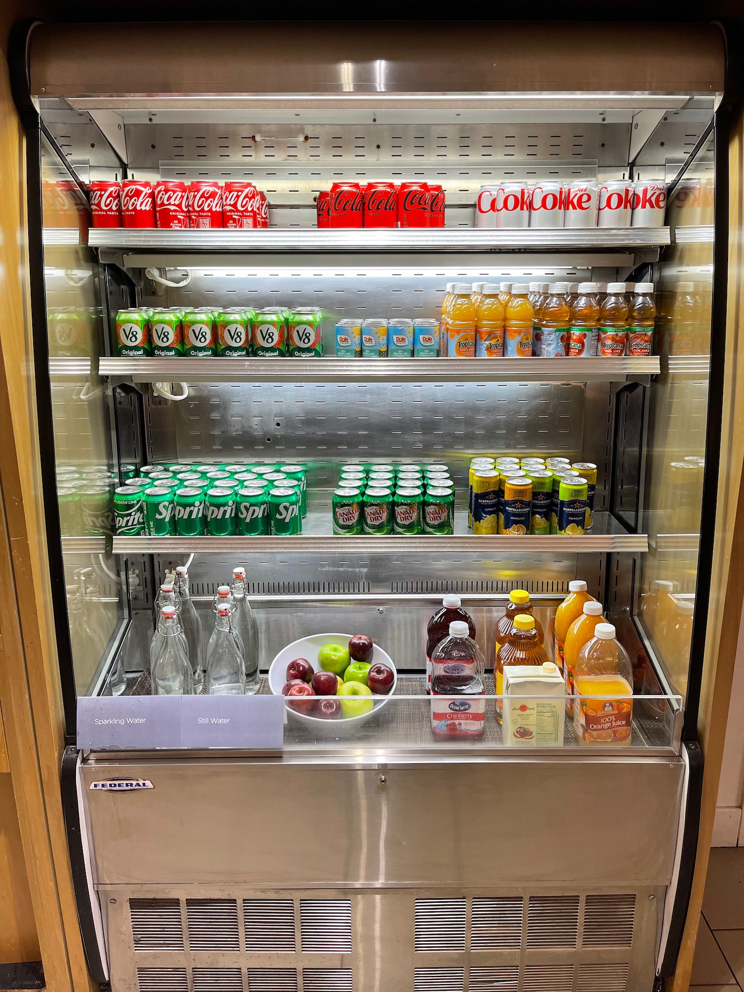 a refrigerator with drinks and fruit