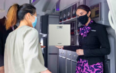 a woman wearing a face mask holding a scale