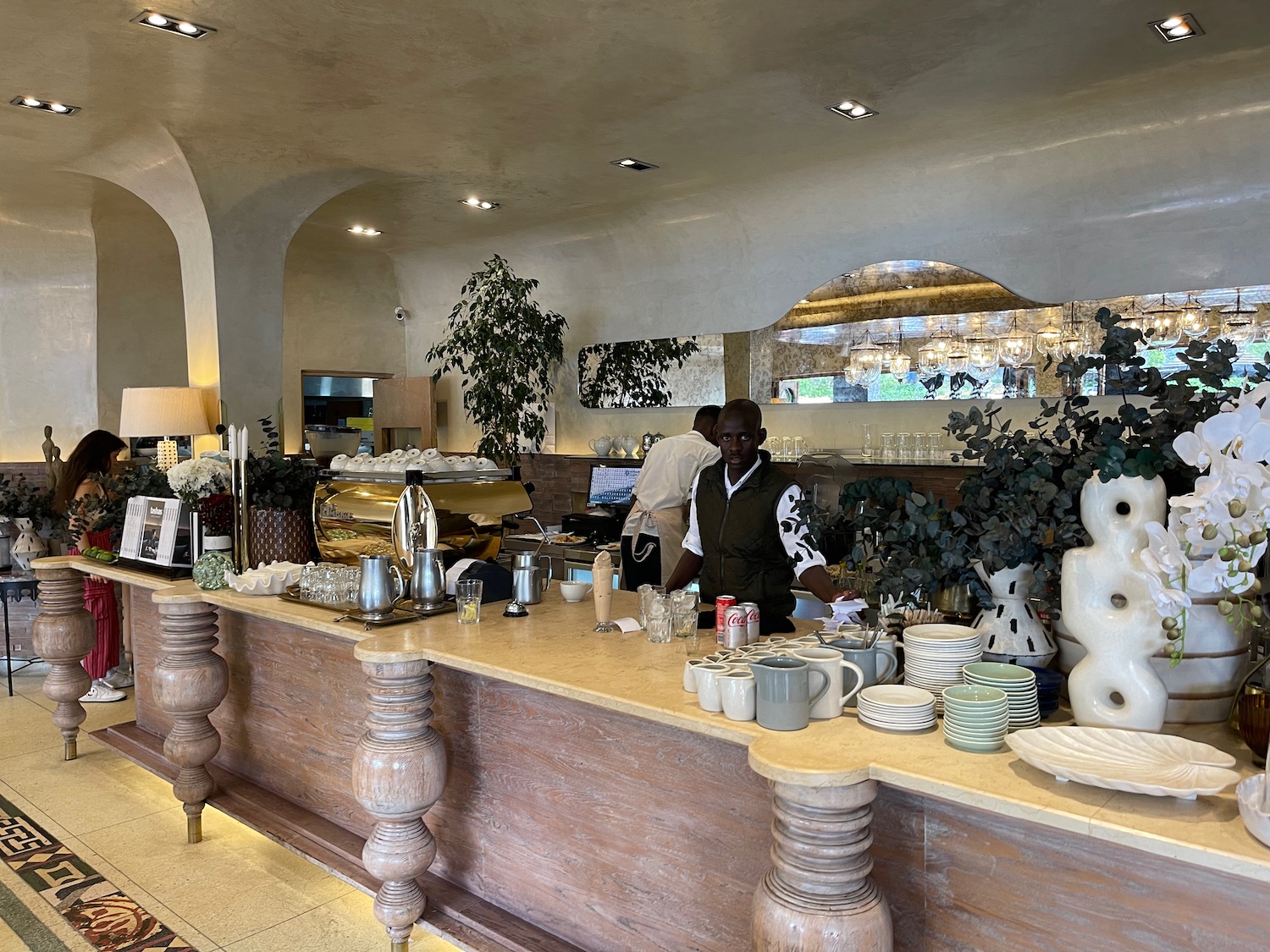 a man standing behind a counter in a restaurant