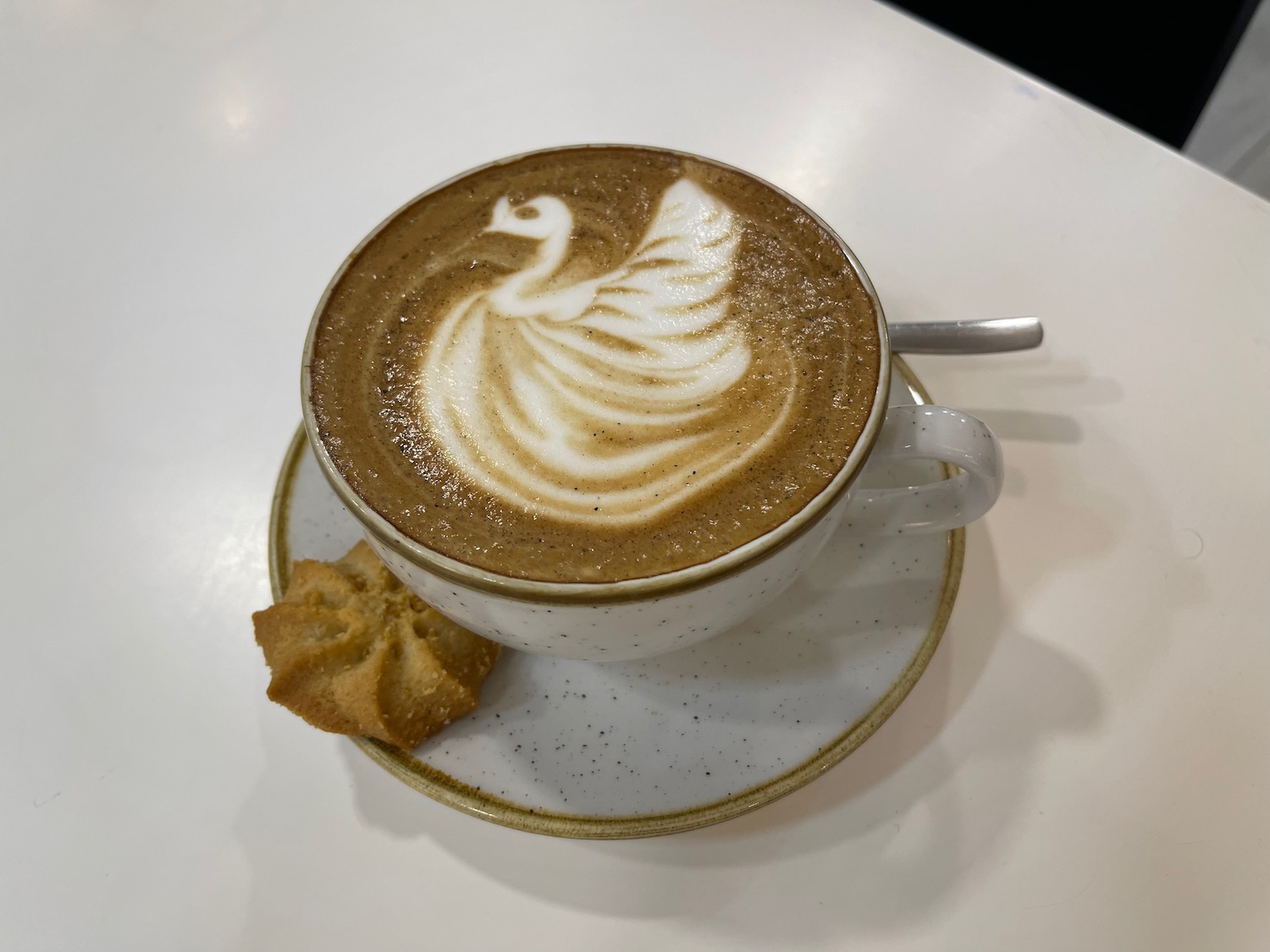 a cup of coffee with a swan design on top