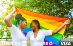 two women holding a rainbow flag