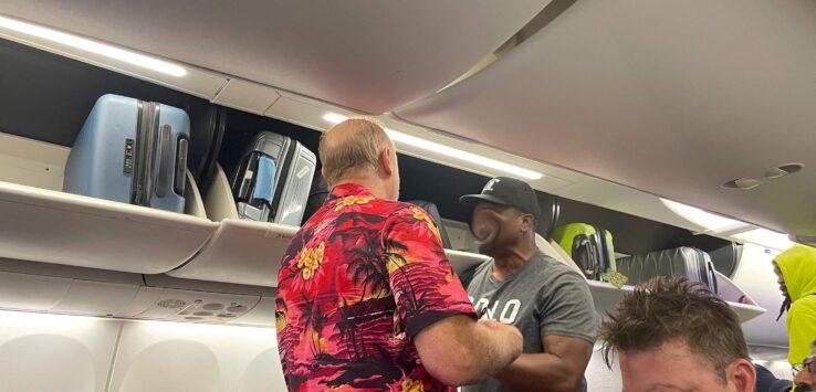 a group of men standing in an airplane