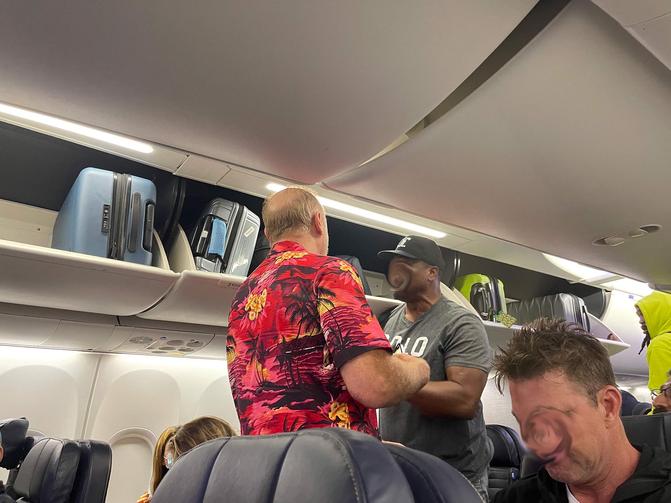 a group of men standing in an airplane