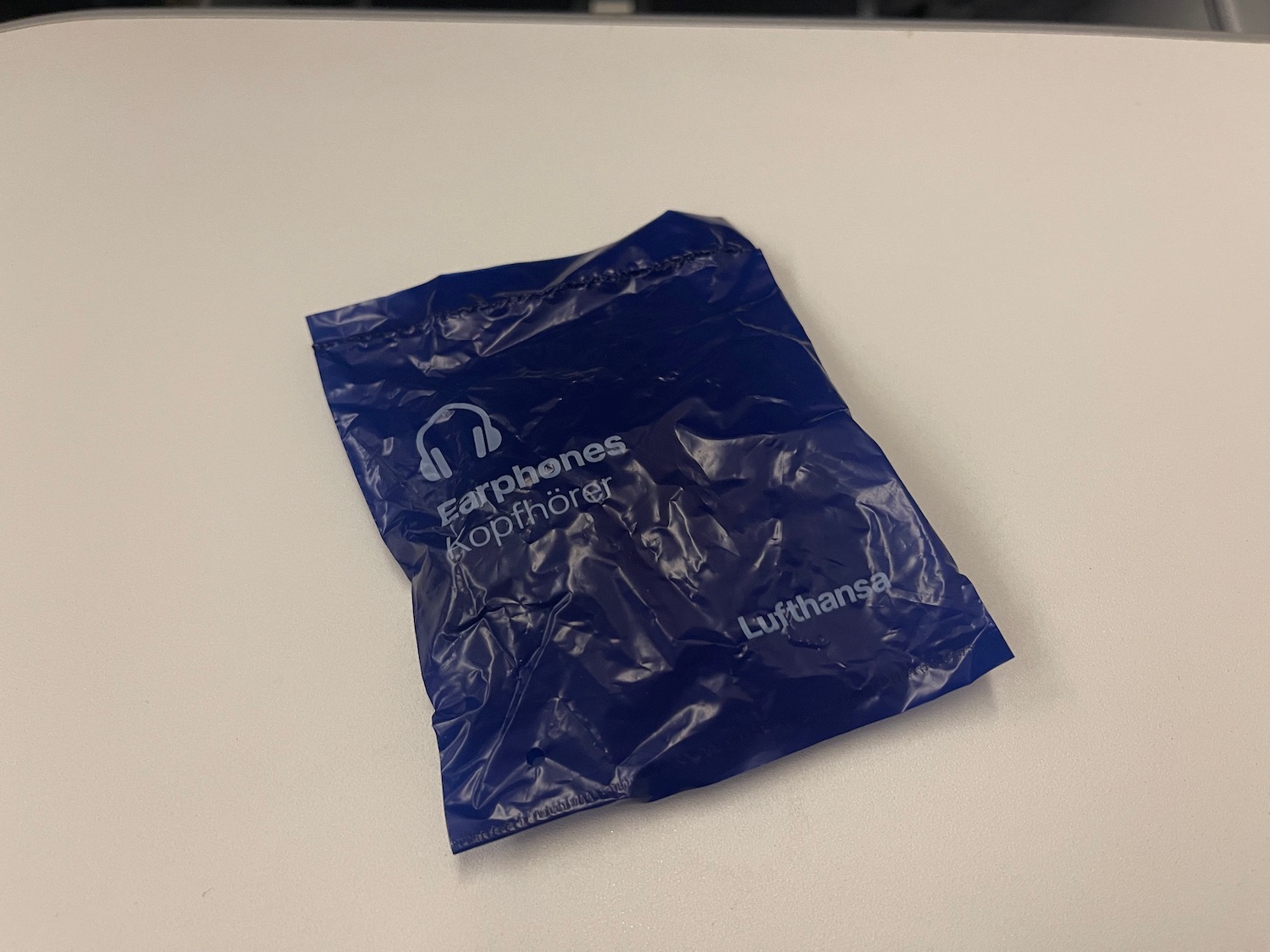 a blue plastic bag on a white surface