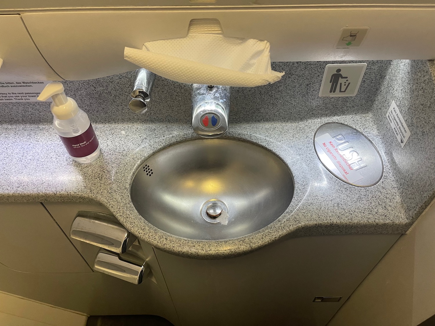 a sink with a tissue and a bottle of soap