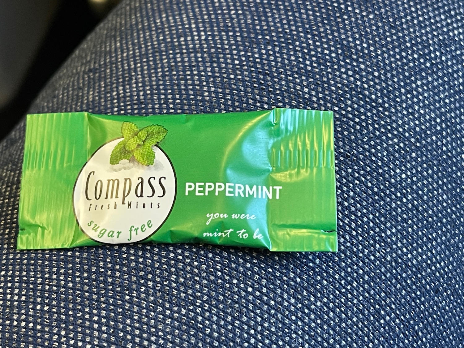 a small packet of peppermint on a blue fabric surface