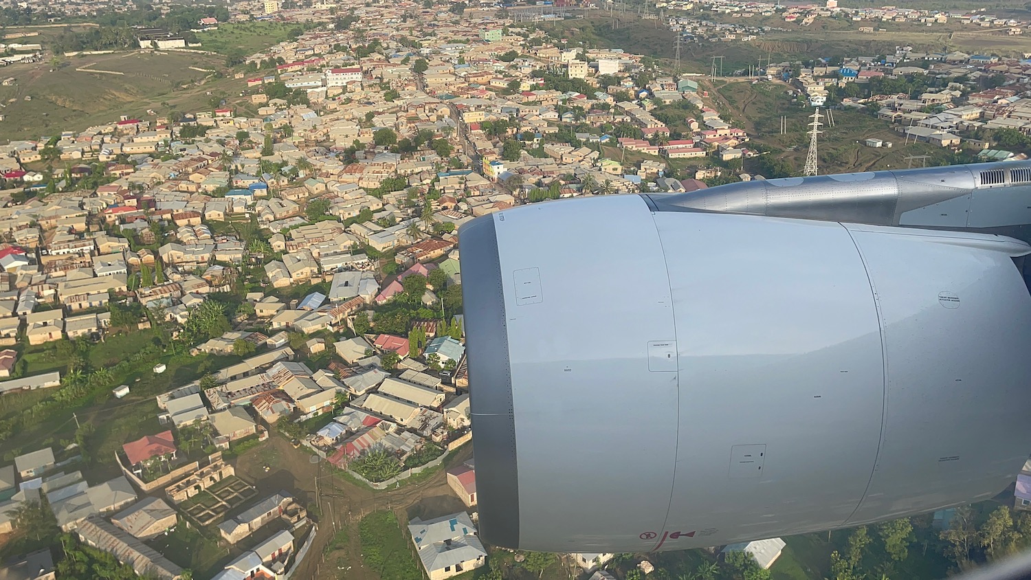 an airplane wing and a city