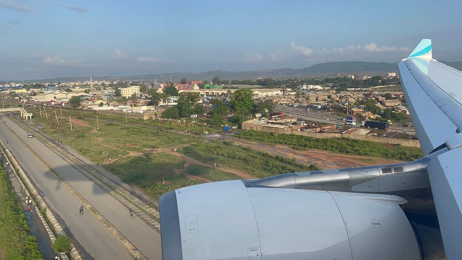 an airplane wing and a city