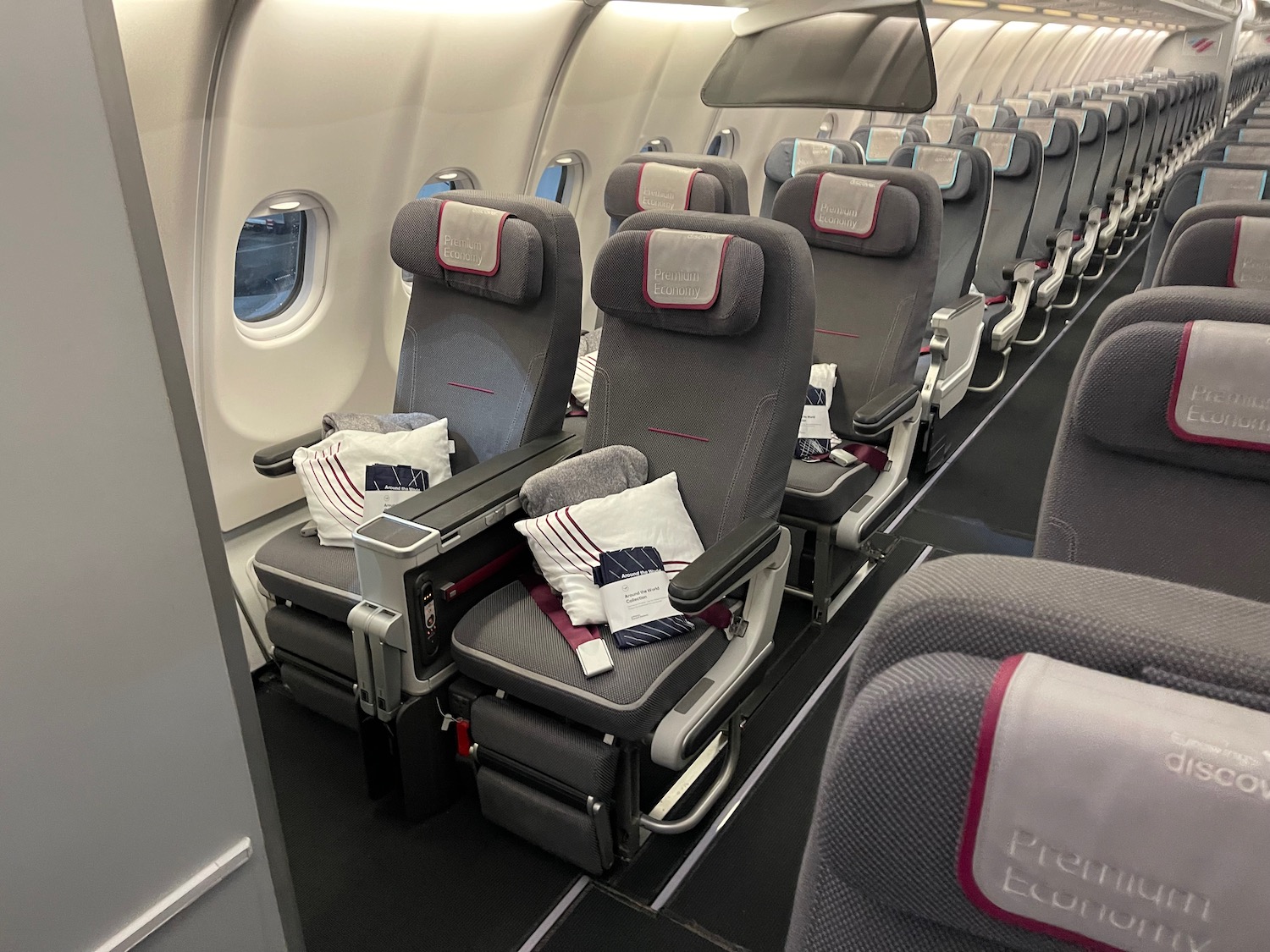 a row of grey seats in an airplane