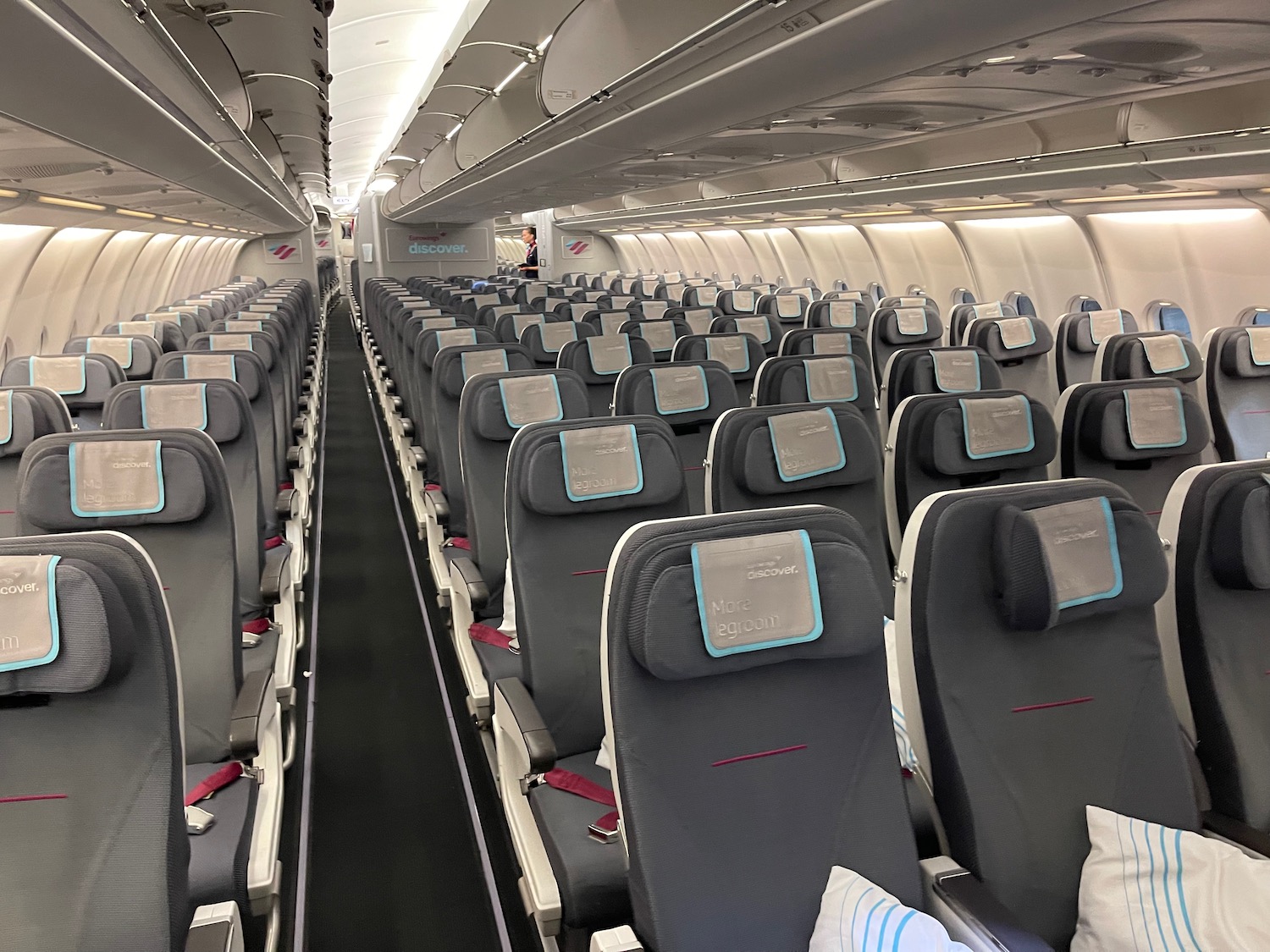 an airplane seats with blue and grey seats