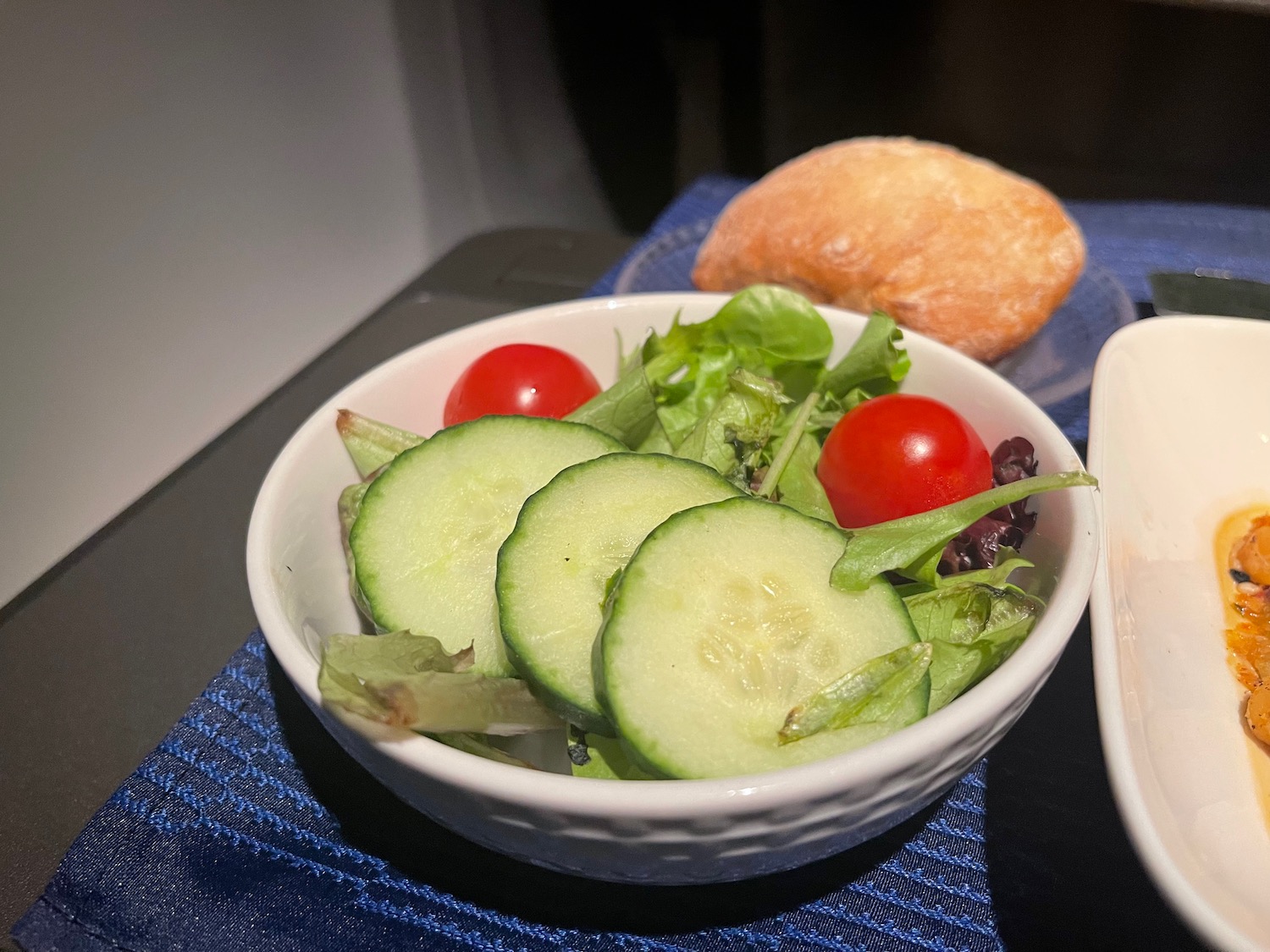 a bowl of salad with cucumbers and tomatoes