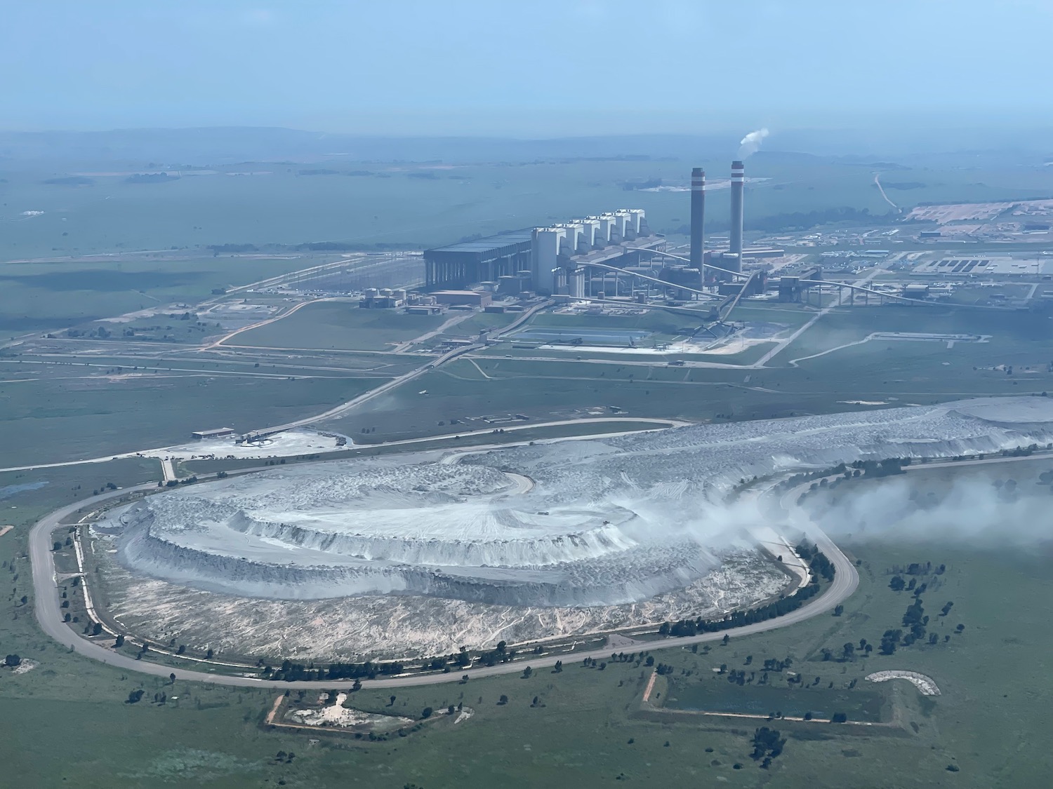 a large factory with smoke stacks