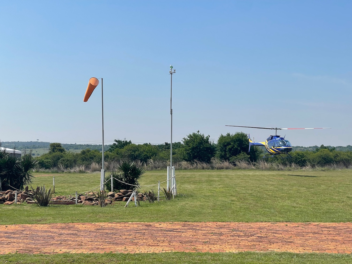 a helicopter flying over a field