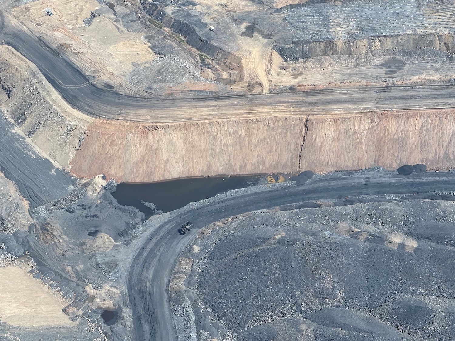 a aerial view of a road and a river