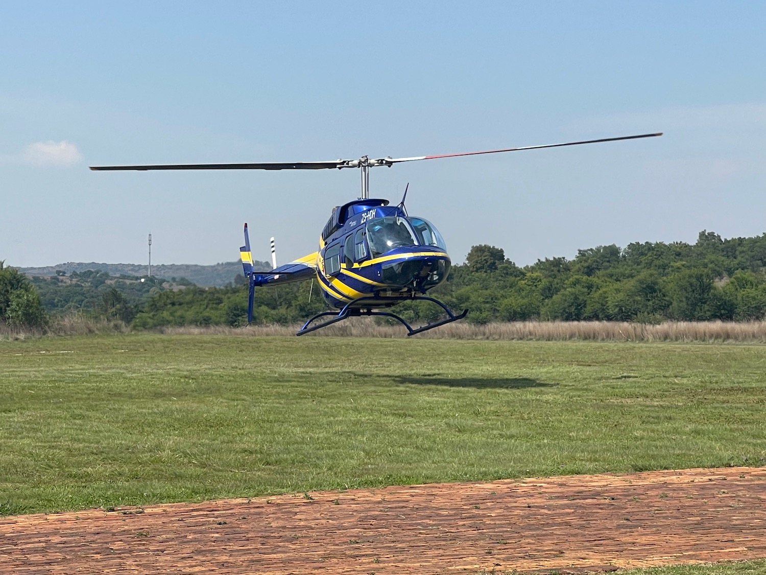 a helicopter flying over a field