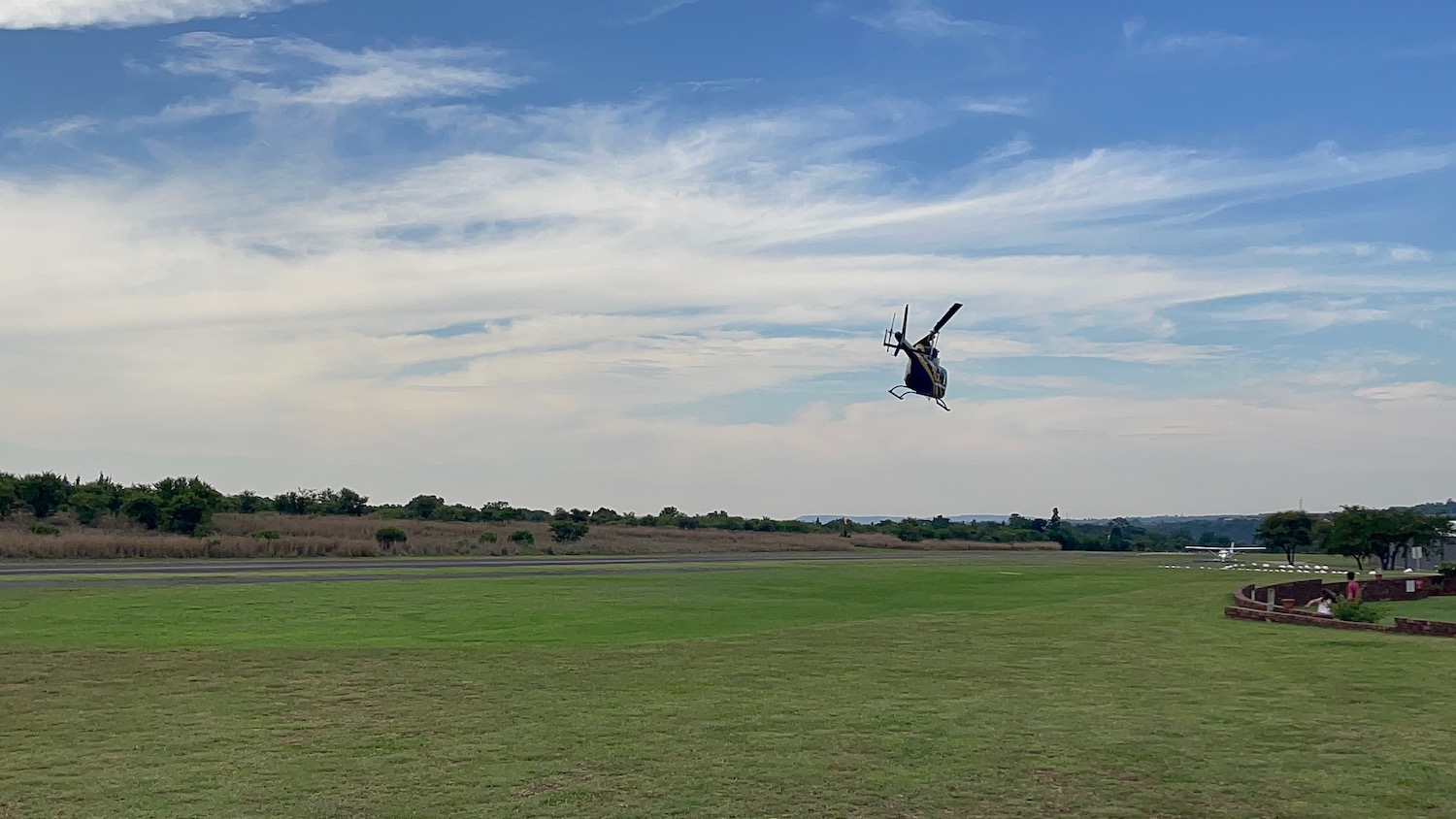 a helicopter flying over a field