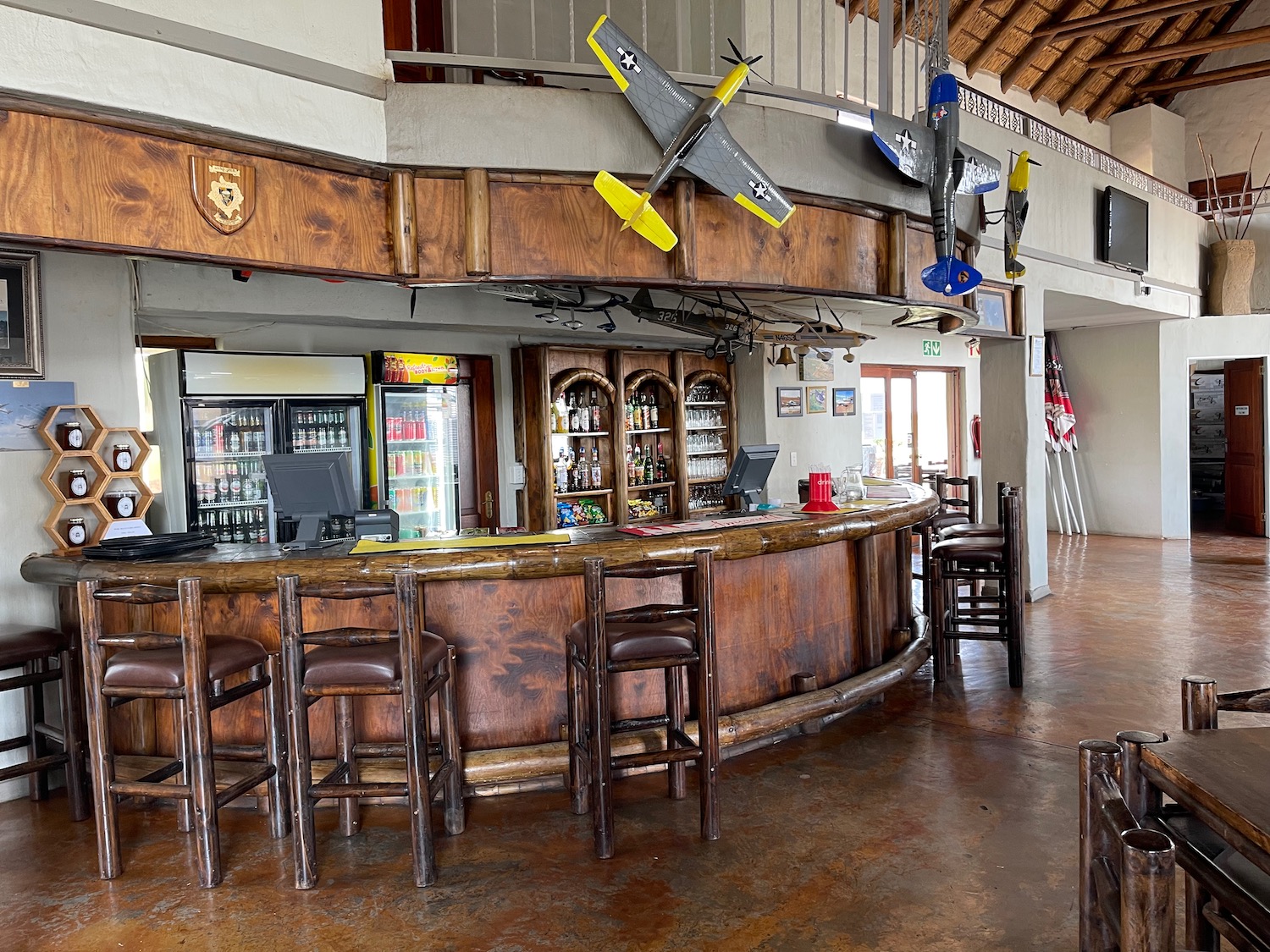 a bar with stools and a counter