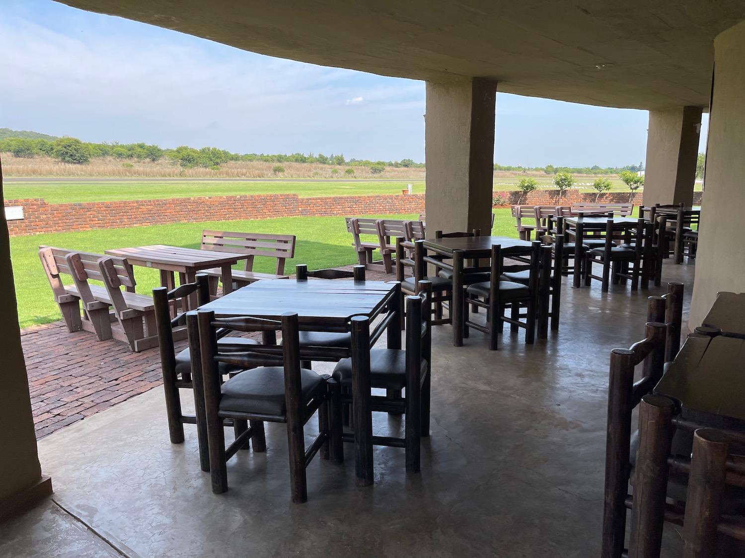 a patio with tables and chairs