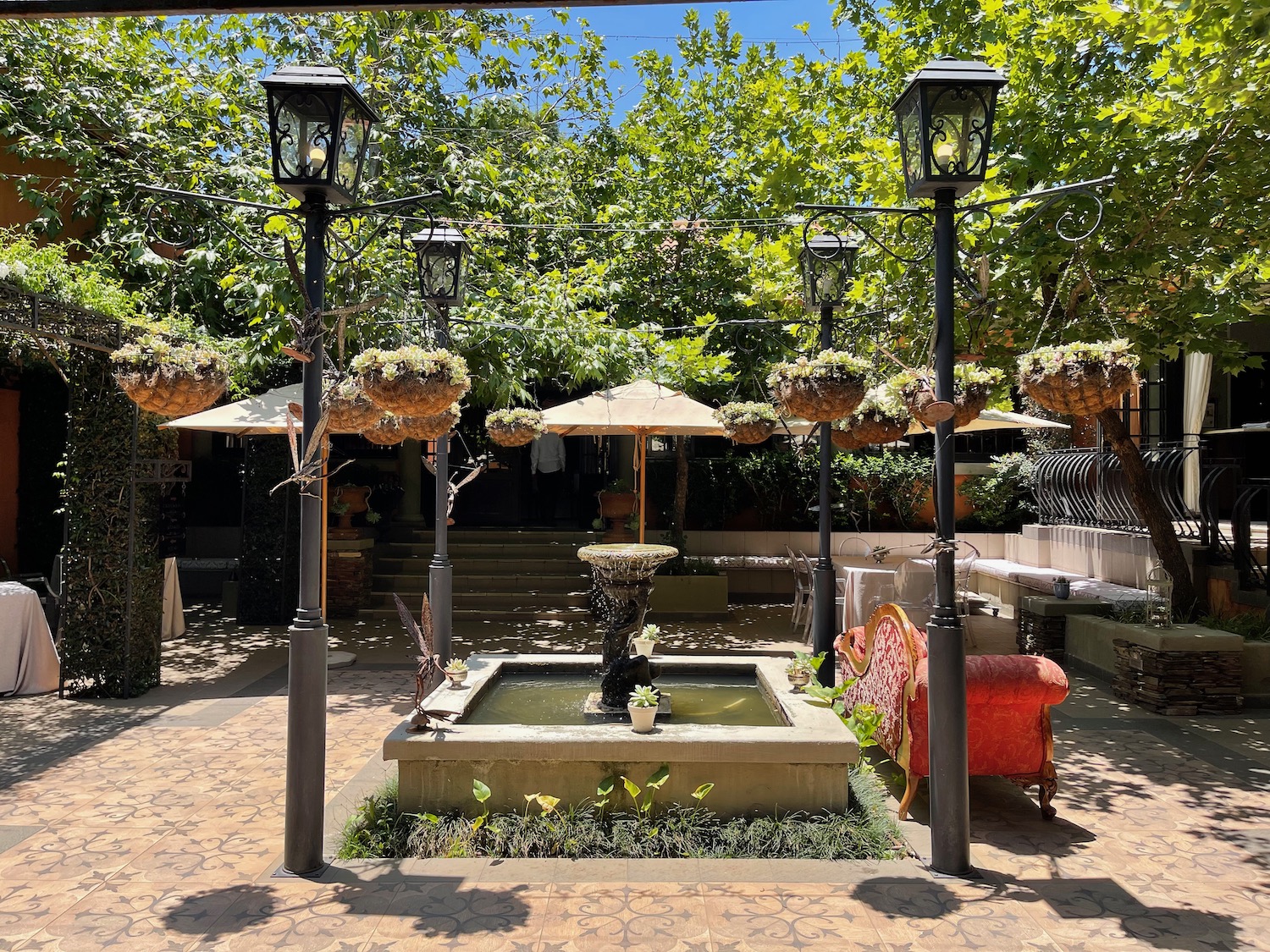 a fountain with a fountain and umbrellas