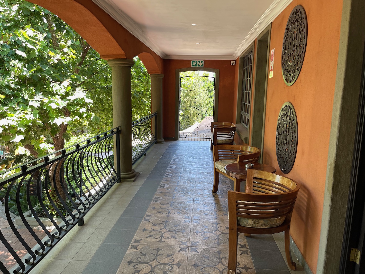 a porch with chairs and a railing