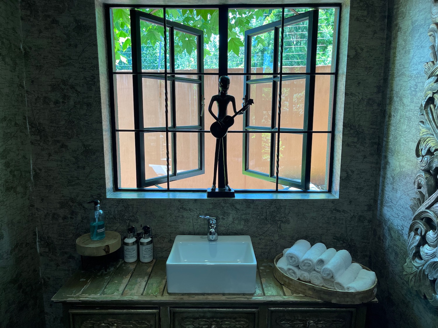a bathroom with a sink and a statue